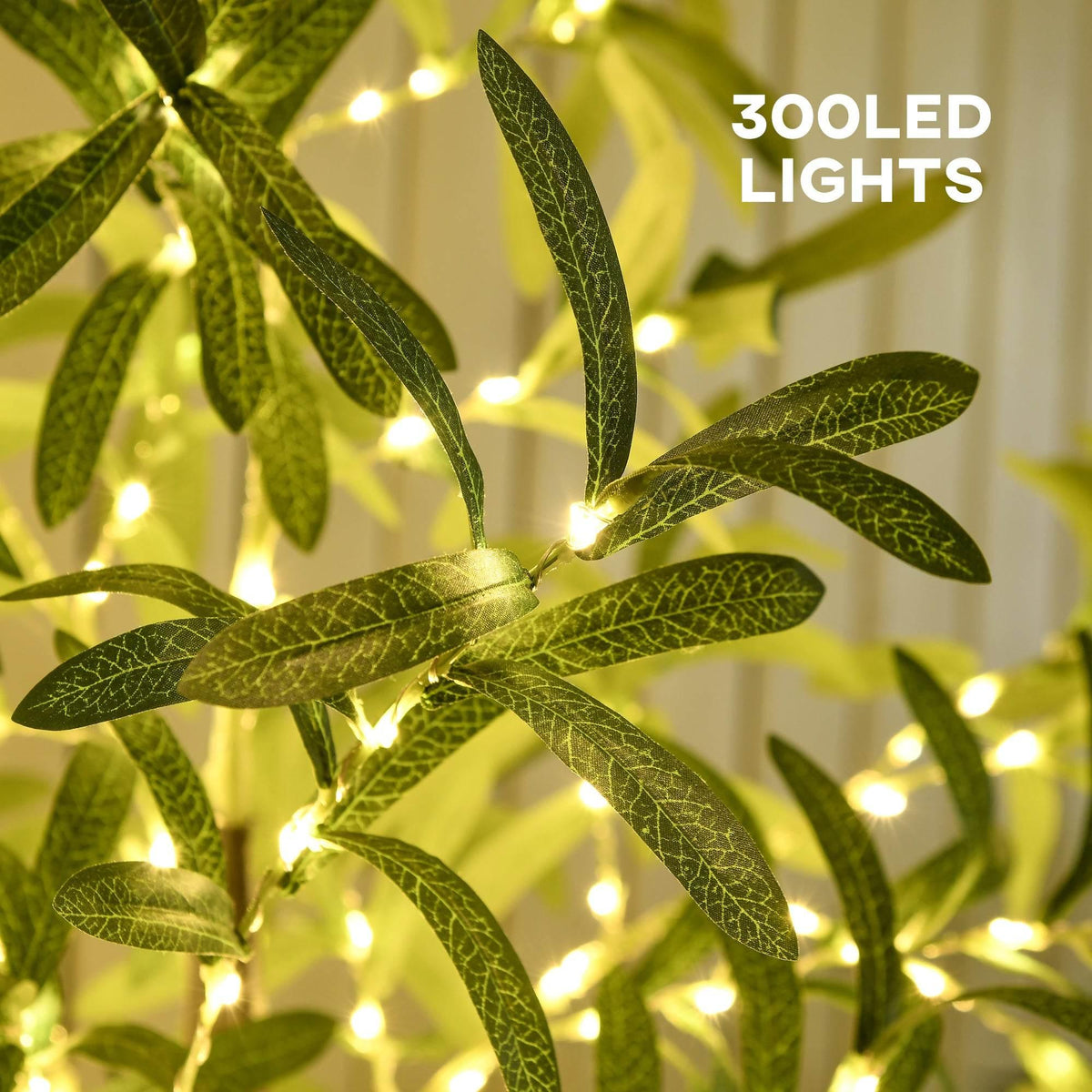 Close-up of prelit olive tree leaves with warm white LED lights