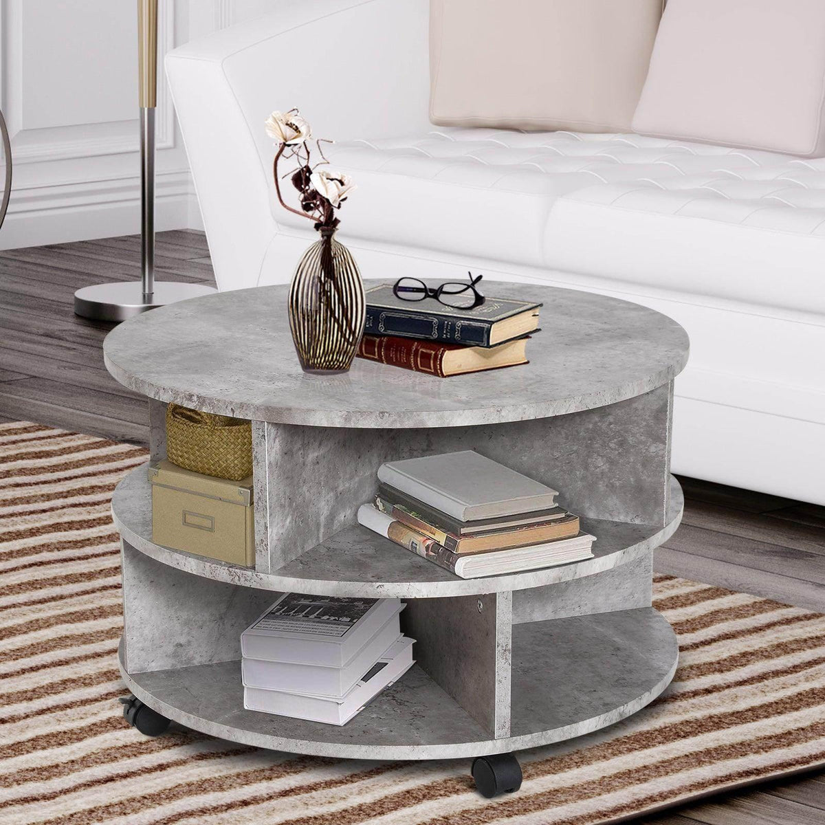 Round two-tier cement-style side table with open shelves and caster wheels