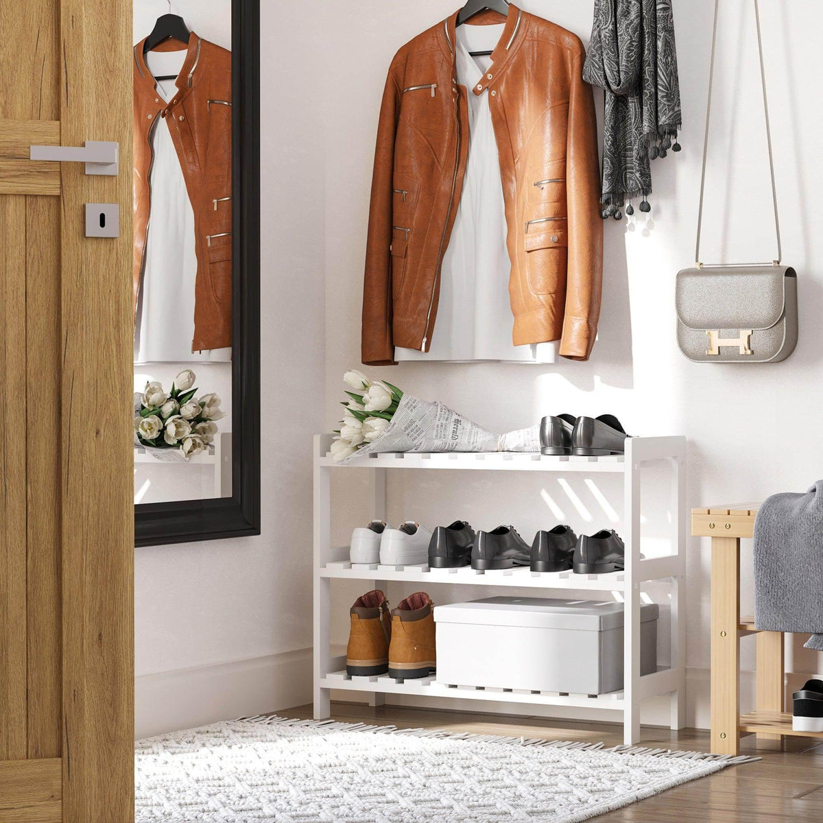 Three-tier shoe rack with white slatted shelves displaying assorted shoes.