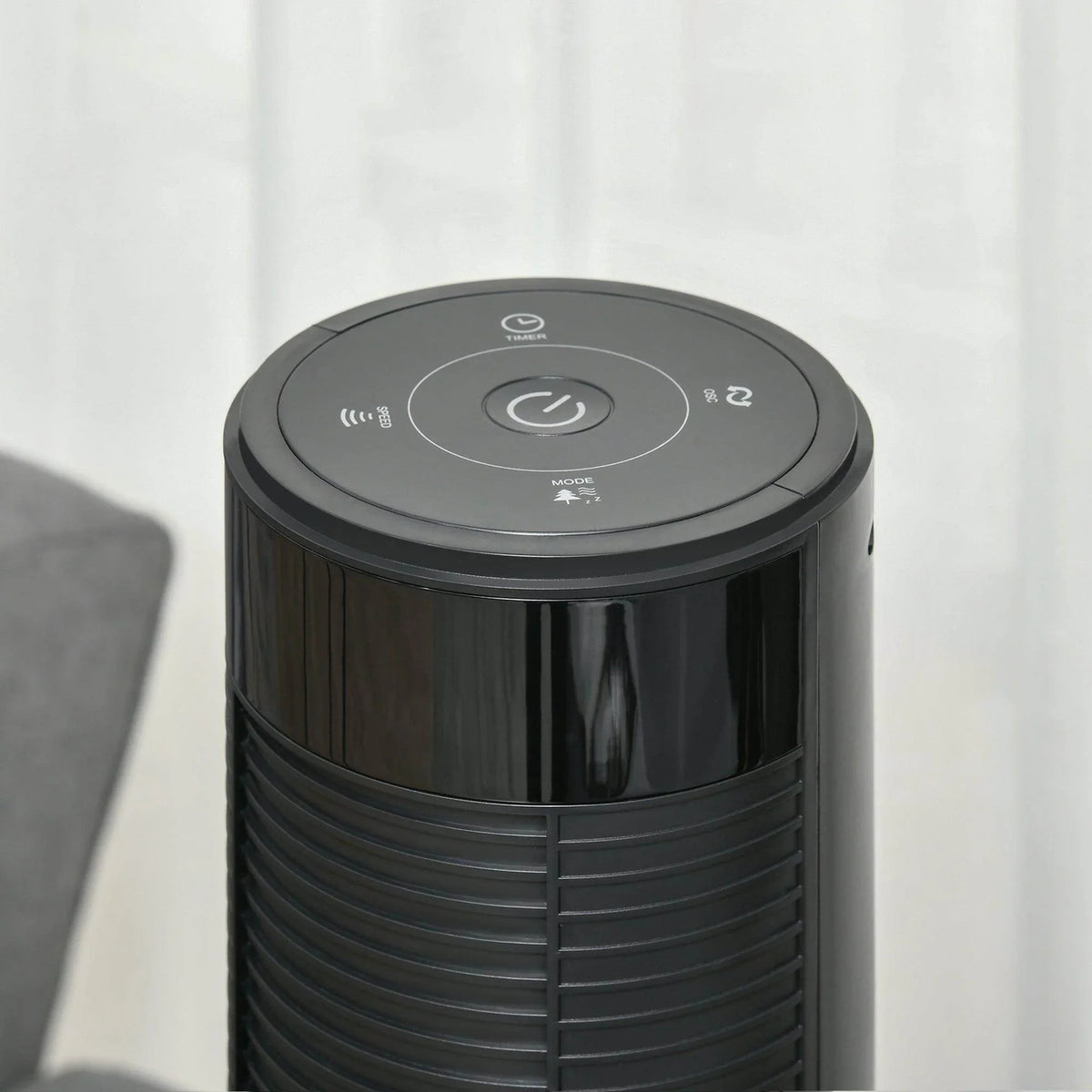 Top view of a black tower fan with smooth control dial and indicator lights