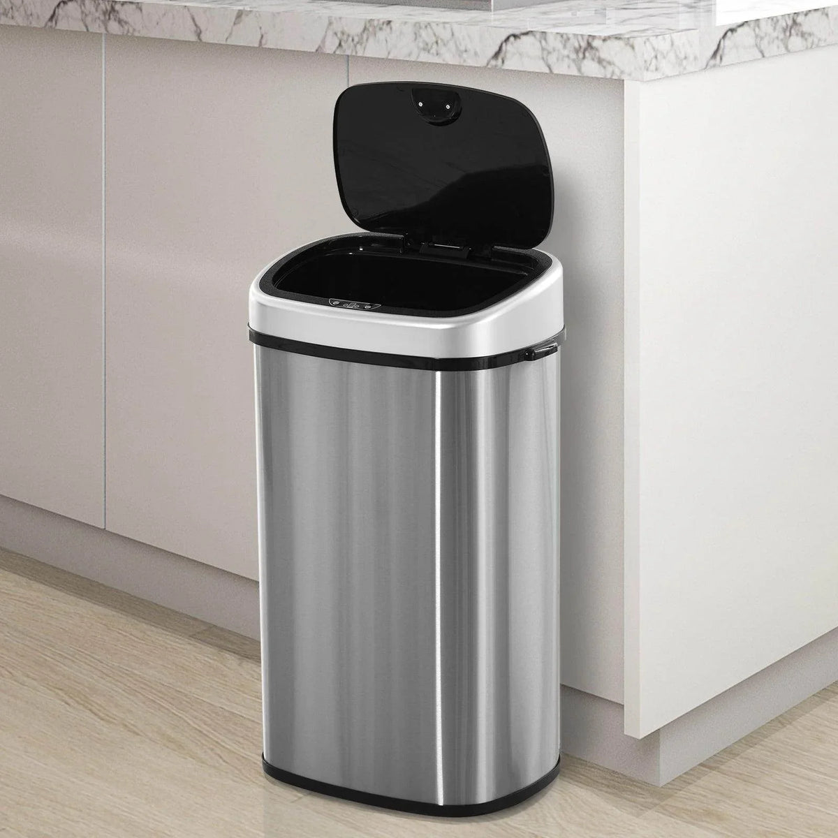 Stainless steel touchless waste bin with black lid popped open and wide inner opening