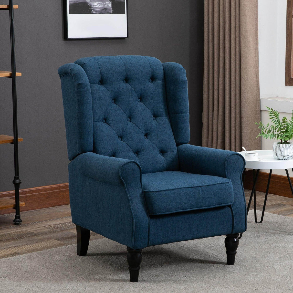 Blue tufted accent armchair with wing back and rolled arms, wooden turned legs