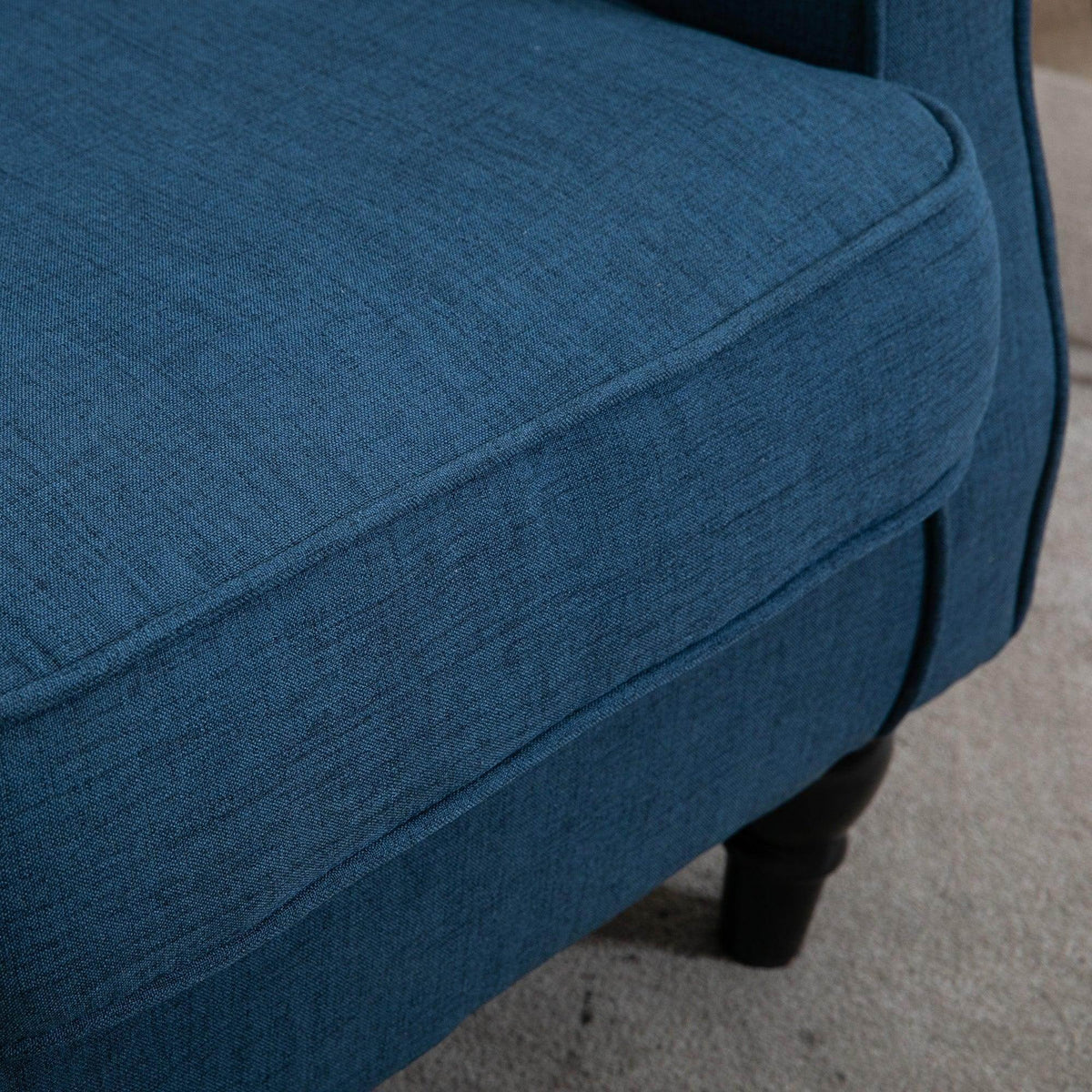 Blue upholstered accent armchair seat cushion with rounded armrest