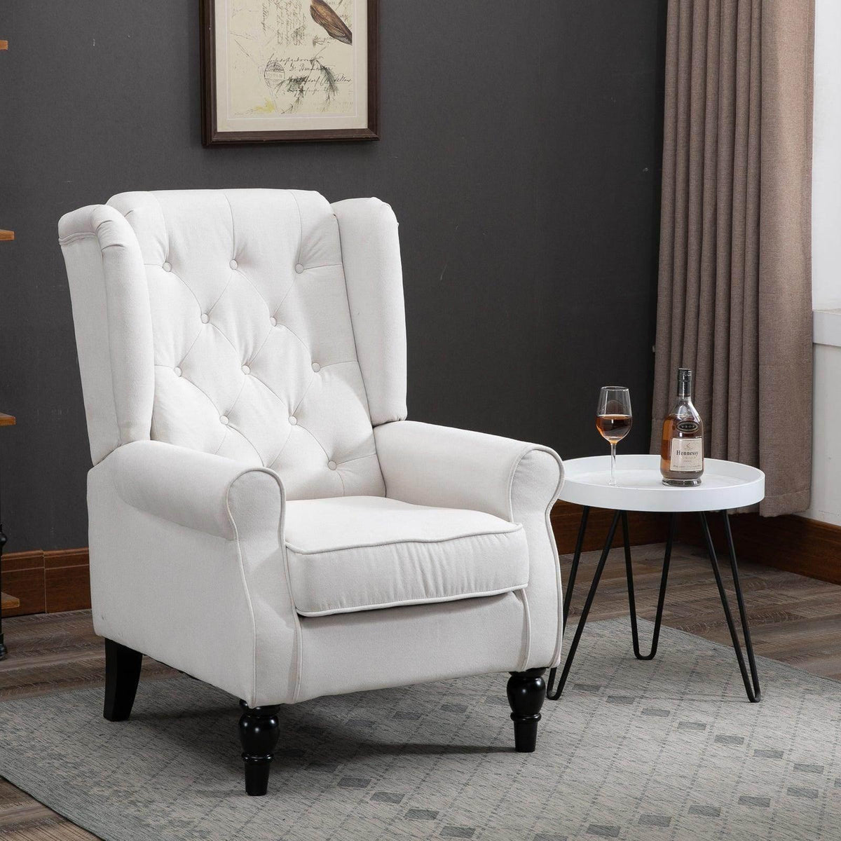 Cream tufted club armchair with rolled arms, deep-diamond button details, black legs.