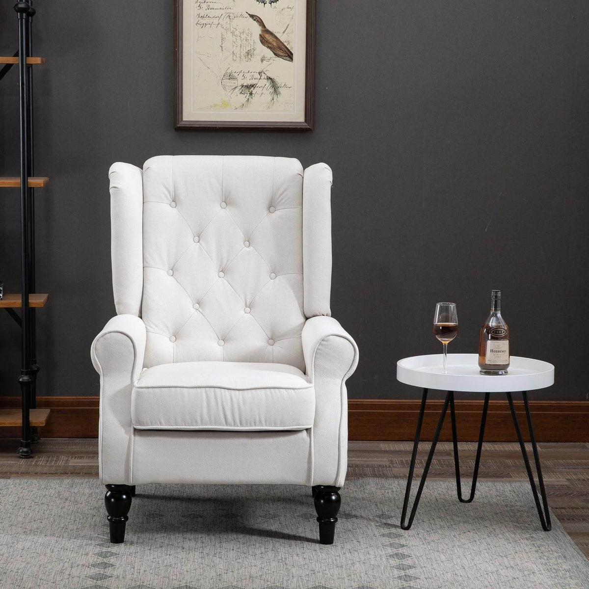 Cream tufted club armchair with high back, rolled arms, button tufting, black turned legs.