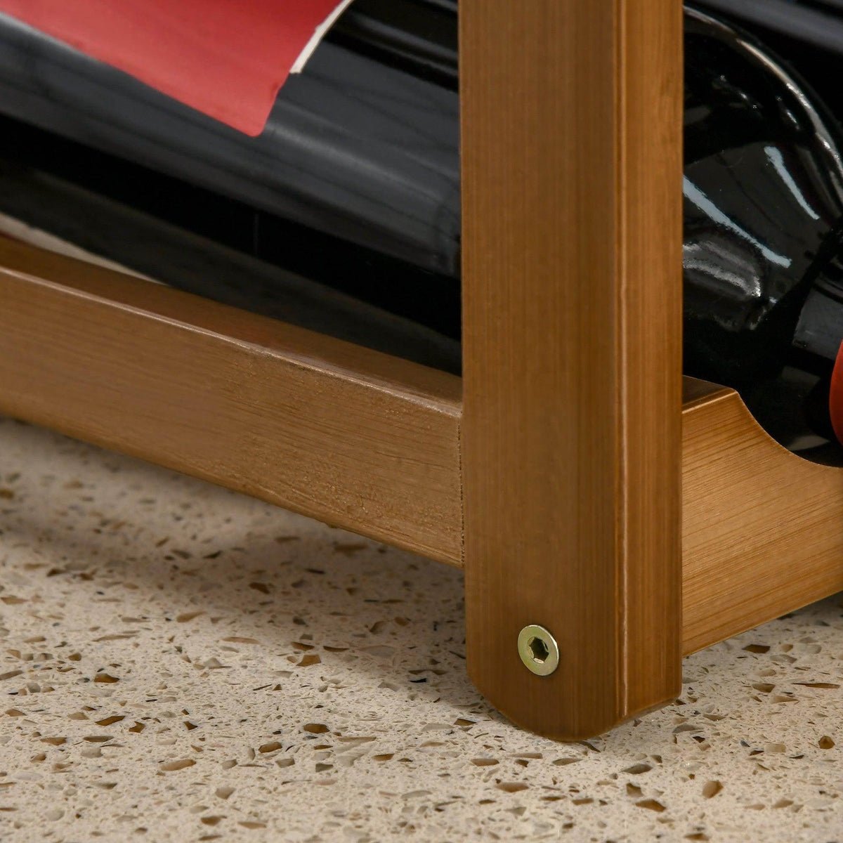 Bamboo wine rack base corner with rounded leg and metal screw on underside.