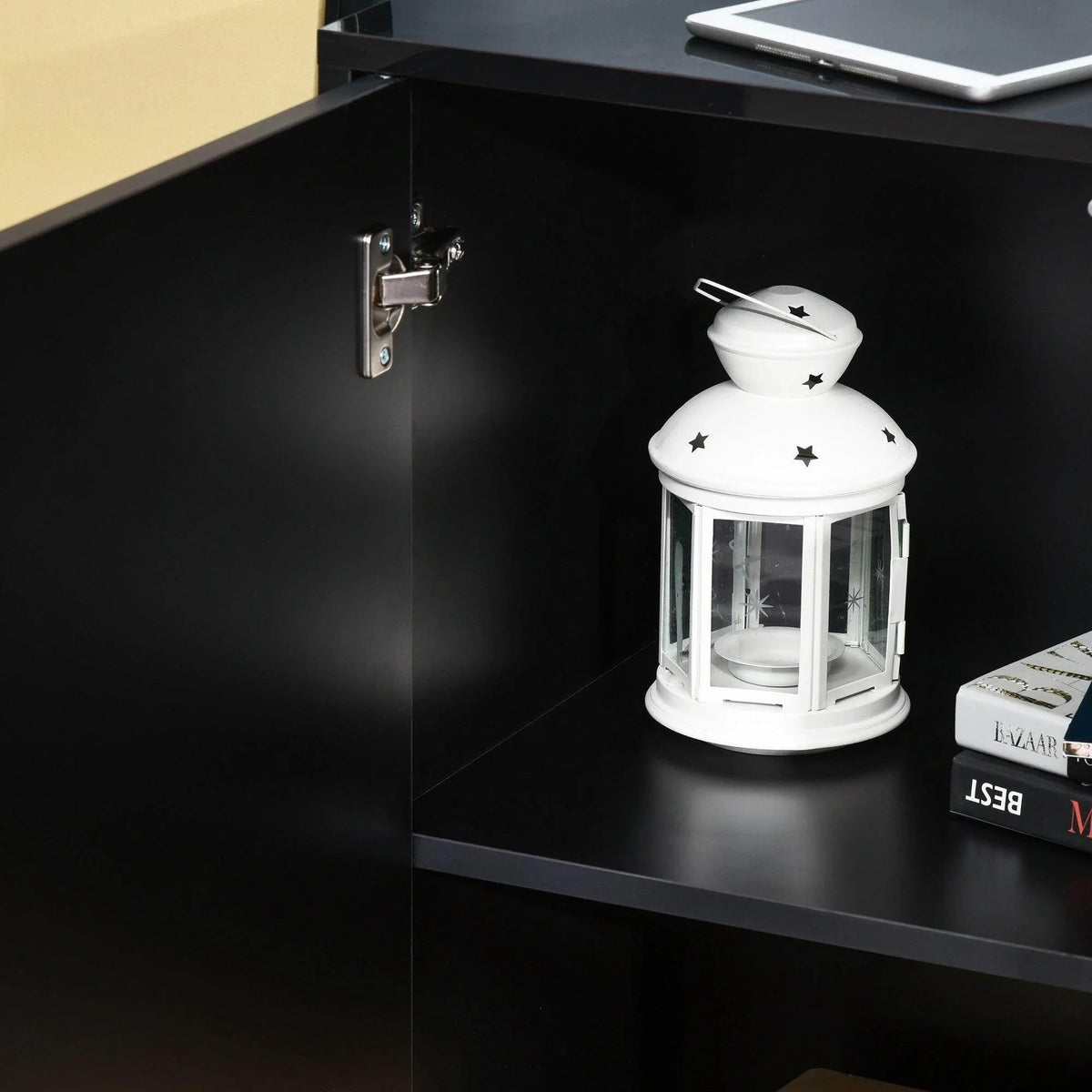 Black sideboard interior shelf with cabinet hinge and concealed storage space.
