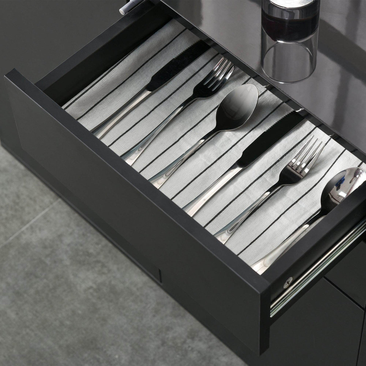 Black high-gloss sideboard cabinet with an open cutlery drawer and divider inserts