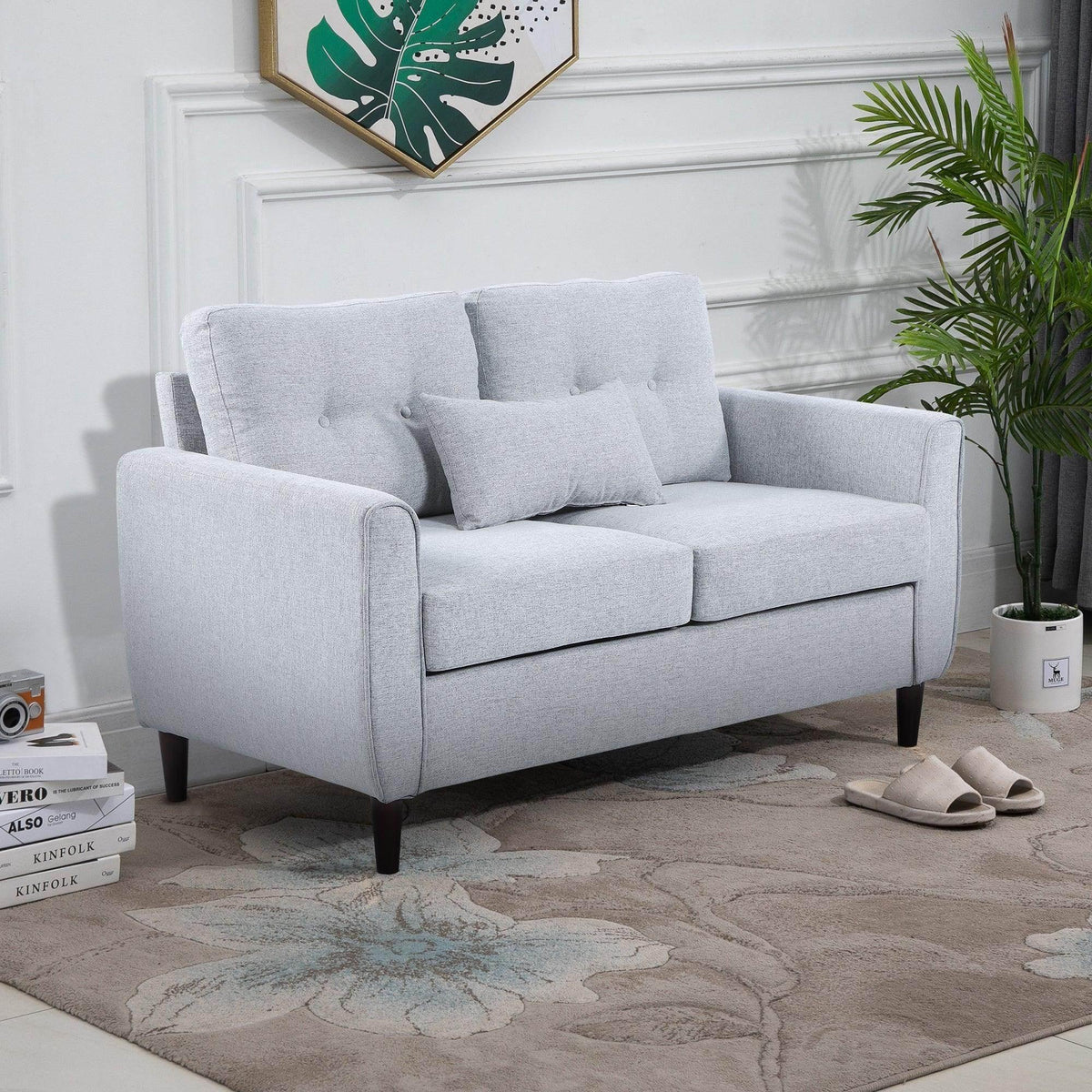 Light grey upholstered loveseat with two seat cushions, square arms, and wooden legs