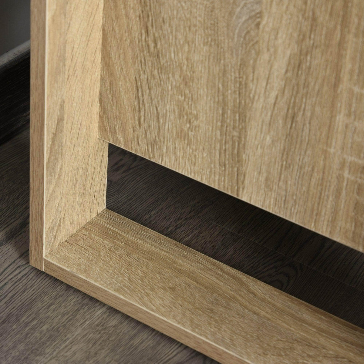 Light oak nightstand lower shelf with dark interior panel beneath drawers.