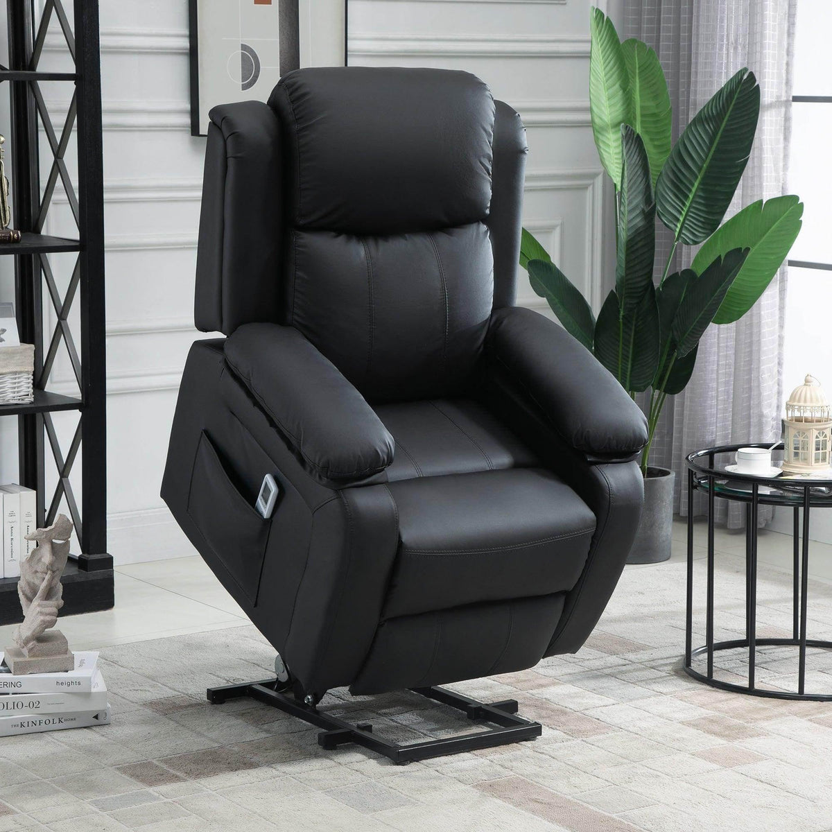 Black power lift recliner chair with padded armrests, reclined seat and footrest.