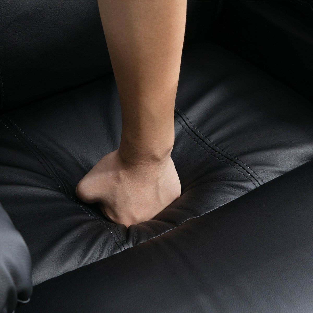 Black recliner cushion with bare feet resting on the footrest area.