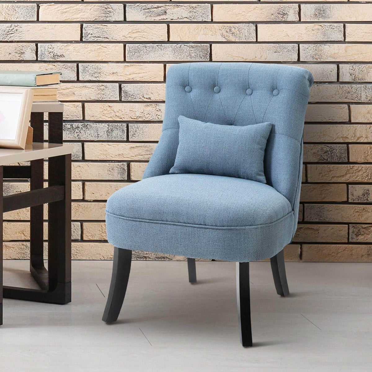 Blue upholstered single armchair with detachable square back cushion and dark wood legs