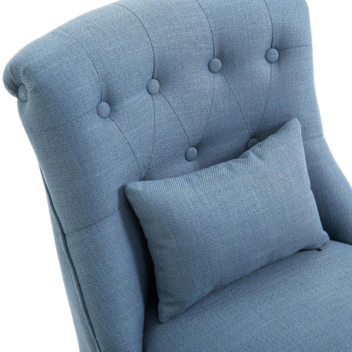 Blue upholstered armchair close-up of tufted back and square cushion