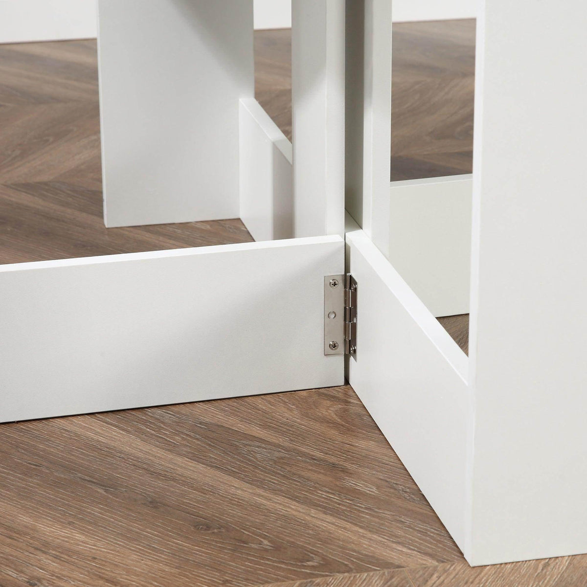White folding bar table detail with open shelf and metal hinge on the folding frame.