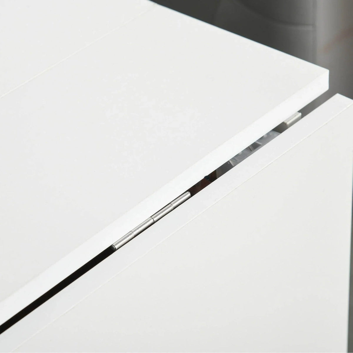 Close-up of folding desk rail support bar under white tabletop
