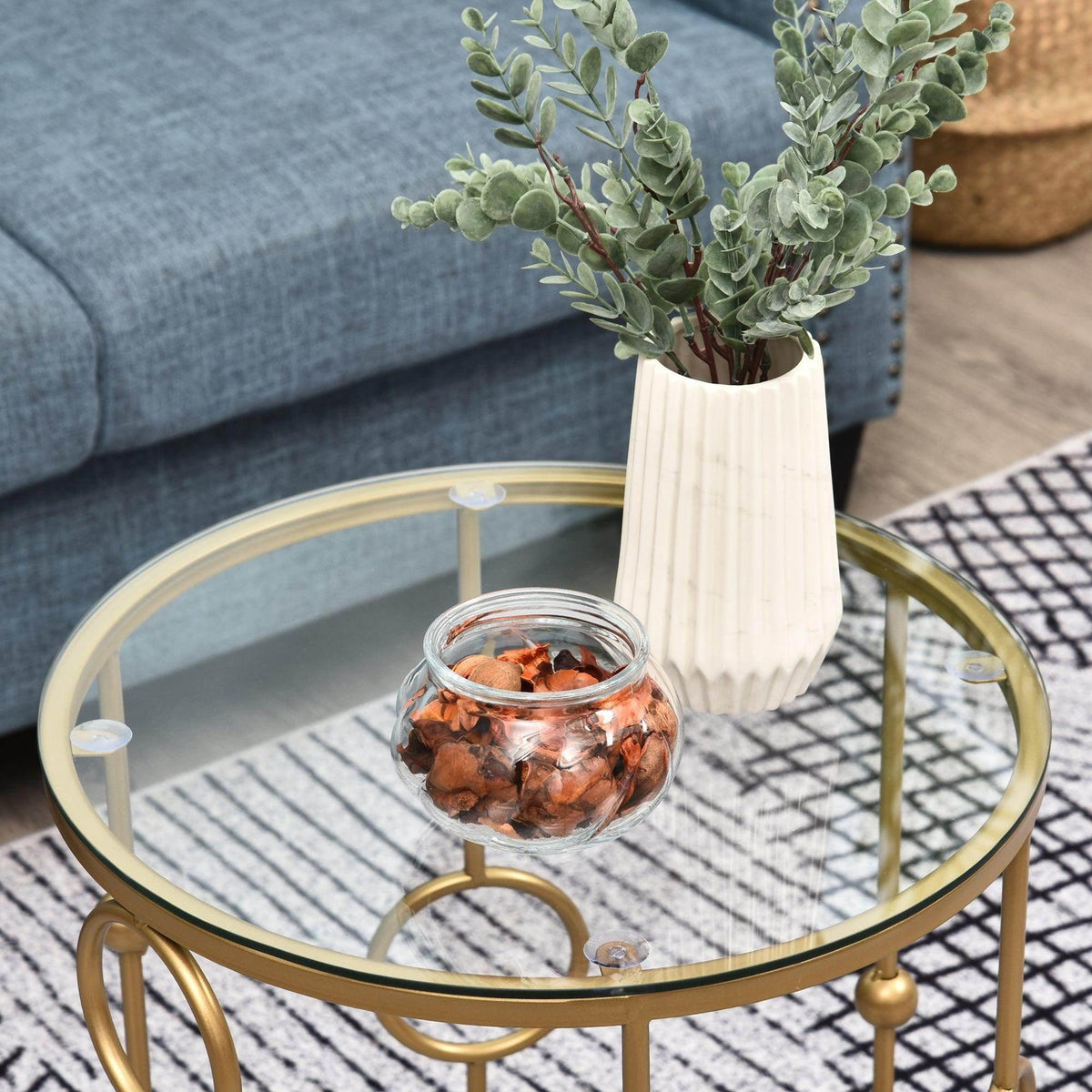 Gold round table with clear glass top and decorative ring base