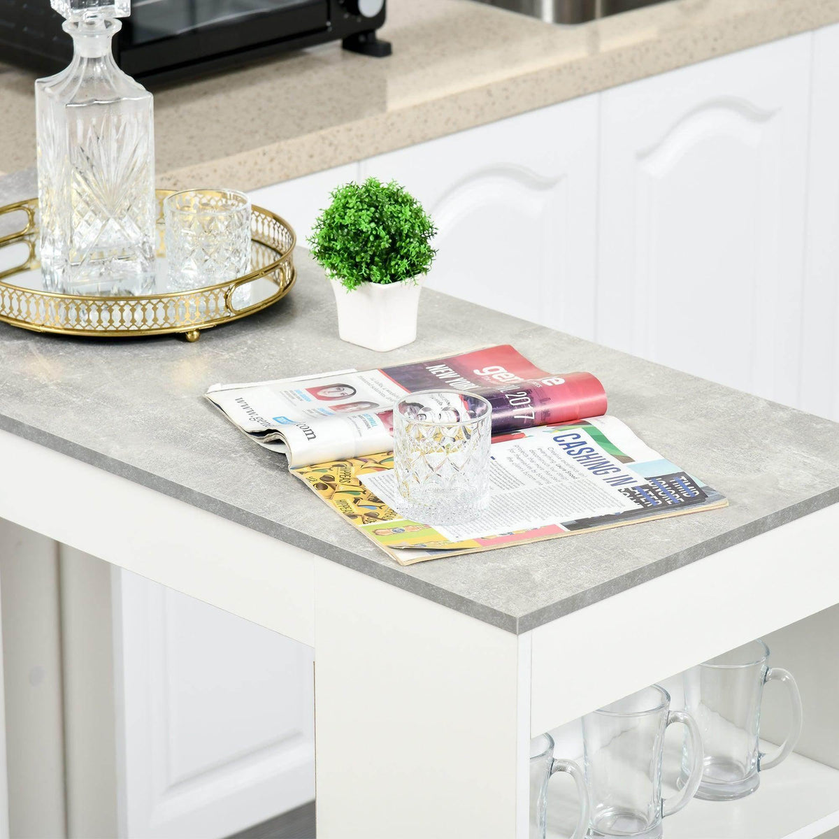 Grey tabletop with magazines and a glass bottle on a white bar table.