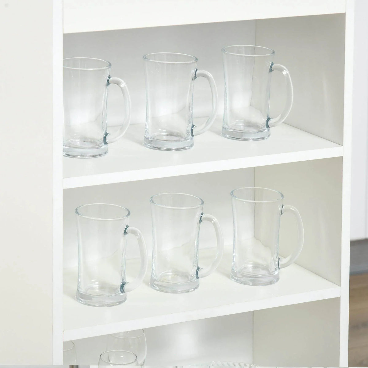 Open 4-tier shelf with clear glass mugs and a barware display in a white cabinet.