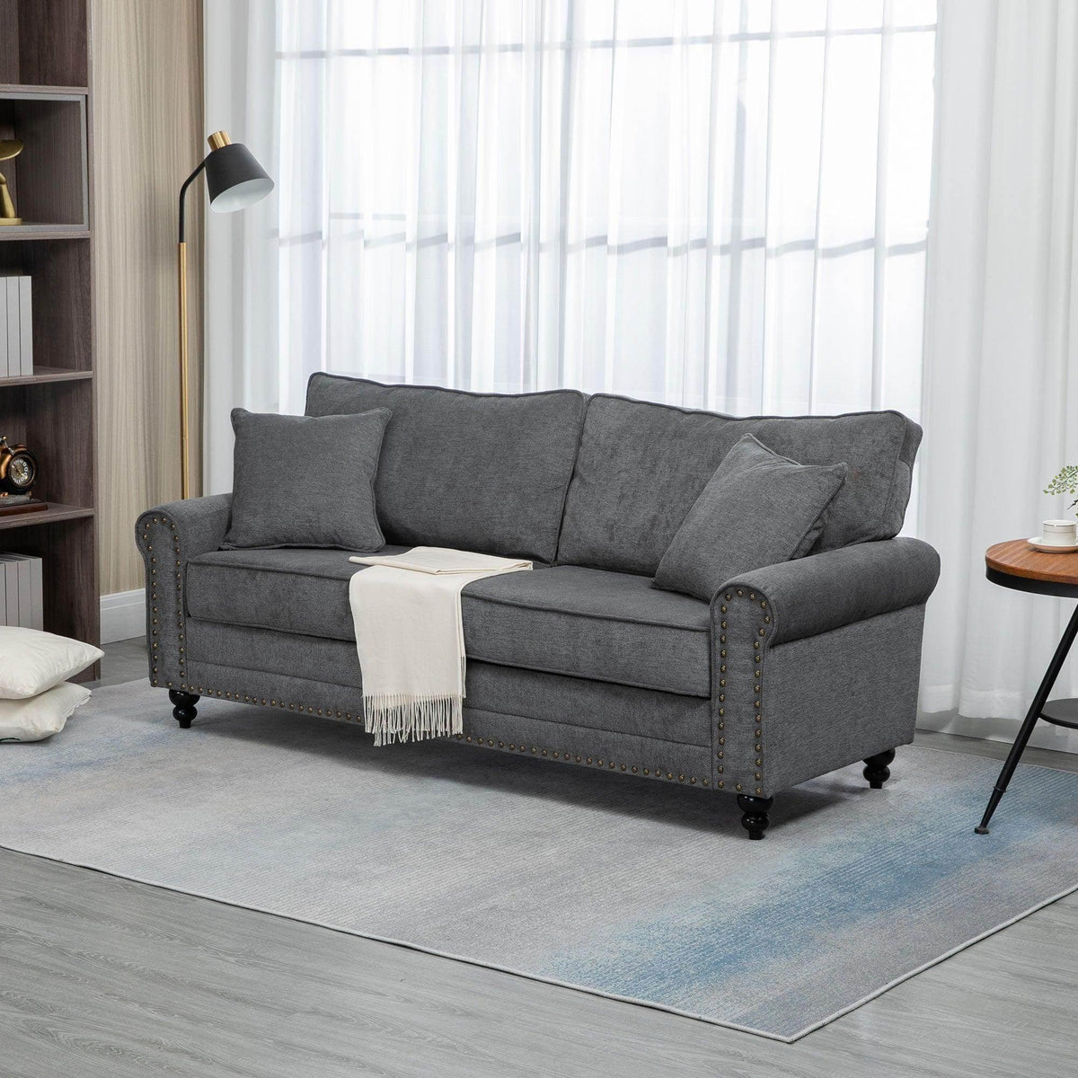 Gray loveseat with rolled arms, two seat cushions, and multiple back cushions
