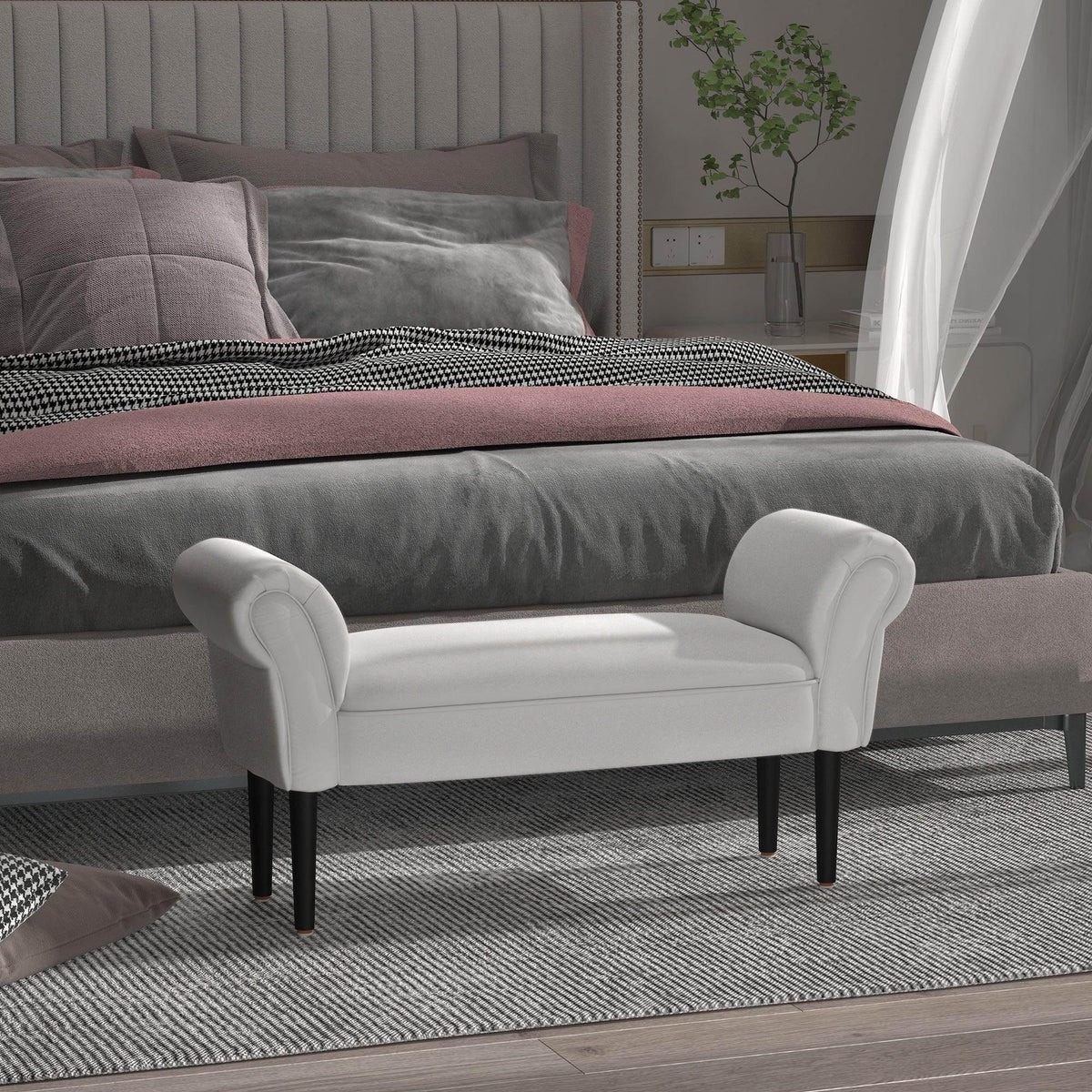 Grey upholstered ottoman bench with rolled arms and black tapered legs