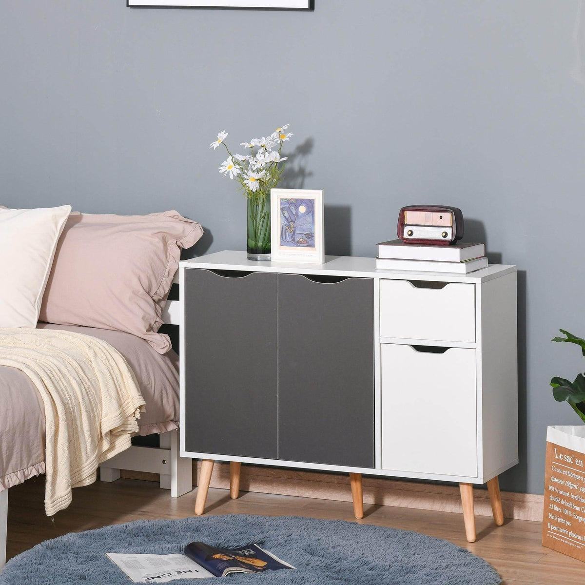 Grey and white sideboard cabinet with drawer, cabinet doors, and tapered wooden legs