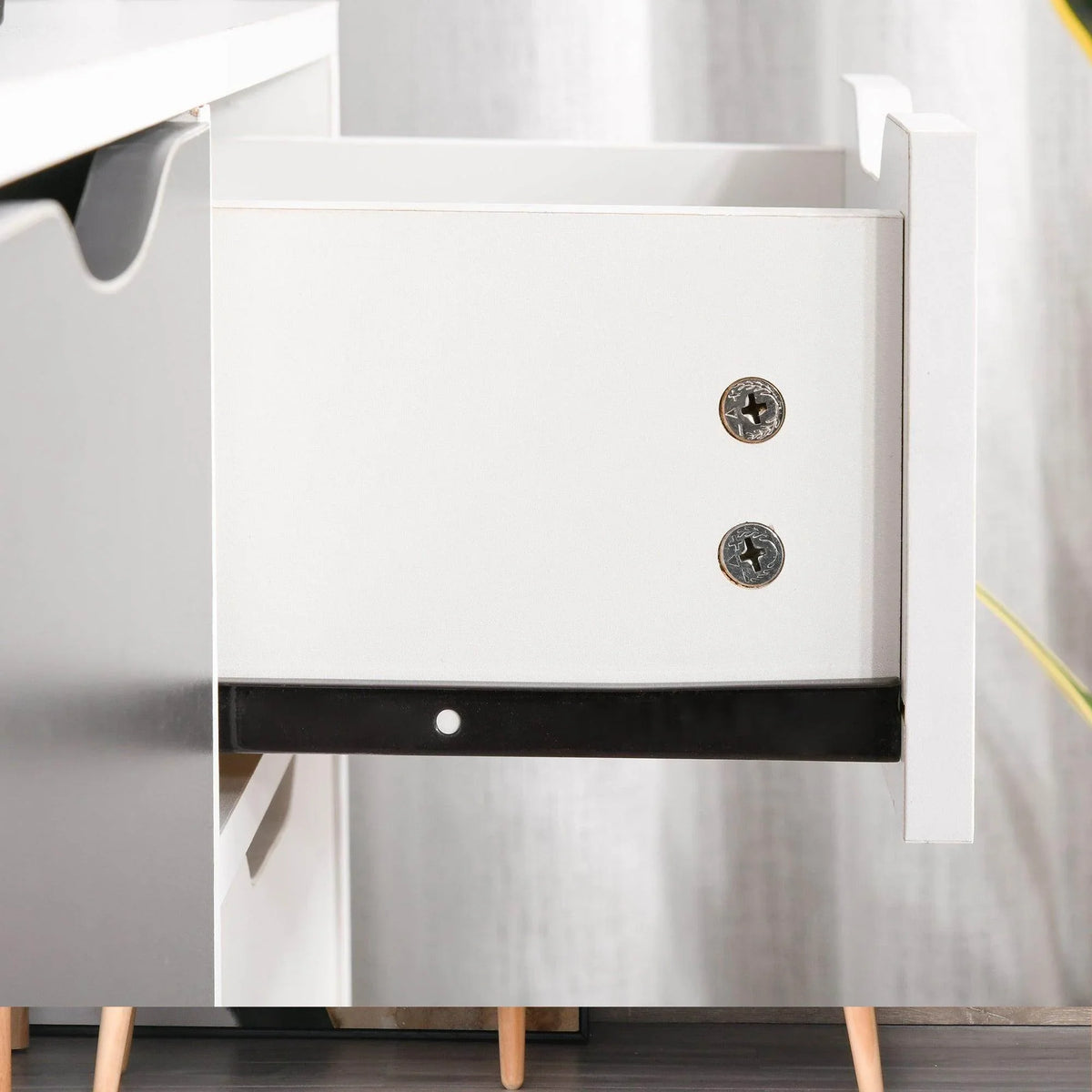 Grey and white sideboard cabinet close-up: drawer front with two circular knobs