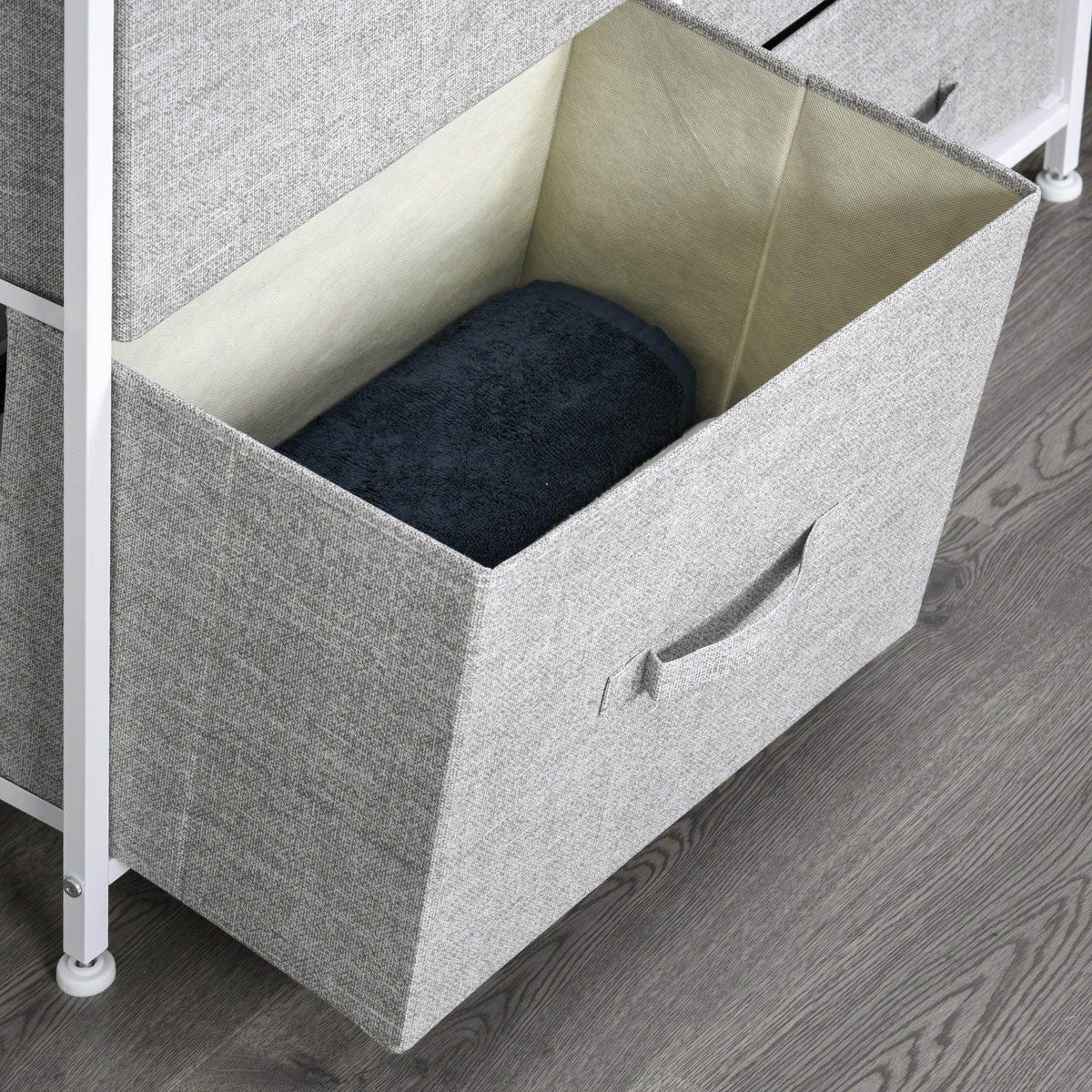 Open grey fabric drawer with beige liner and dark blue item inside, white frame
