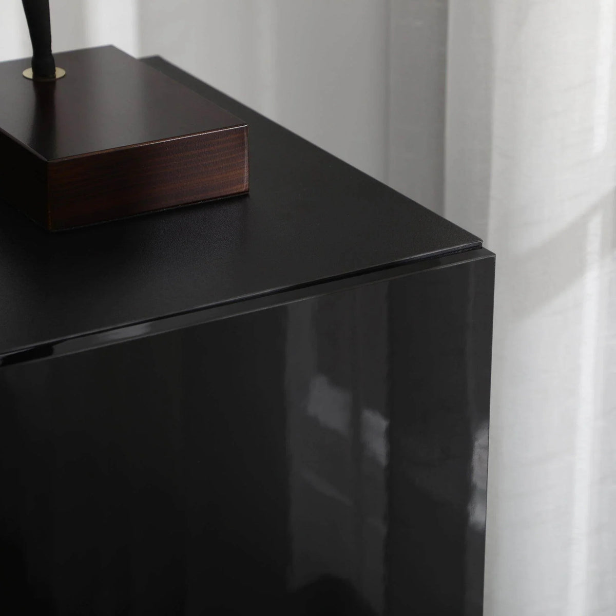 High-gloss black cabinet side panel with smooth reflective finish