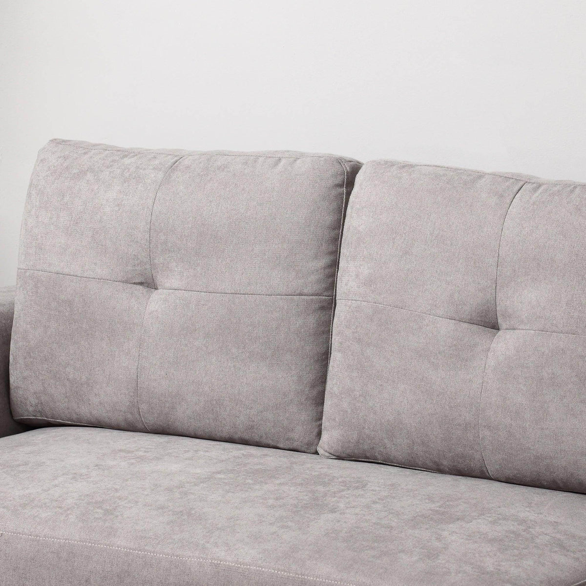 Grey upholstered sofa bed backrest with vertical stitched panels