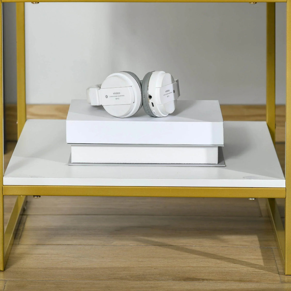 White open shelf with electrical devices and round outlet unit, gold frame nightstand