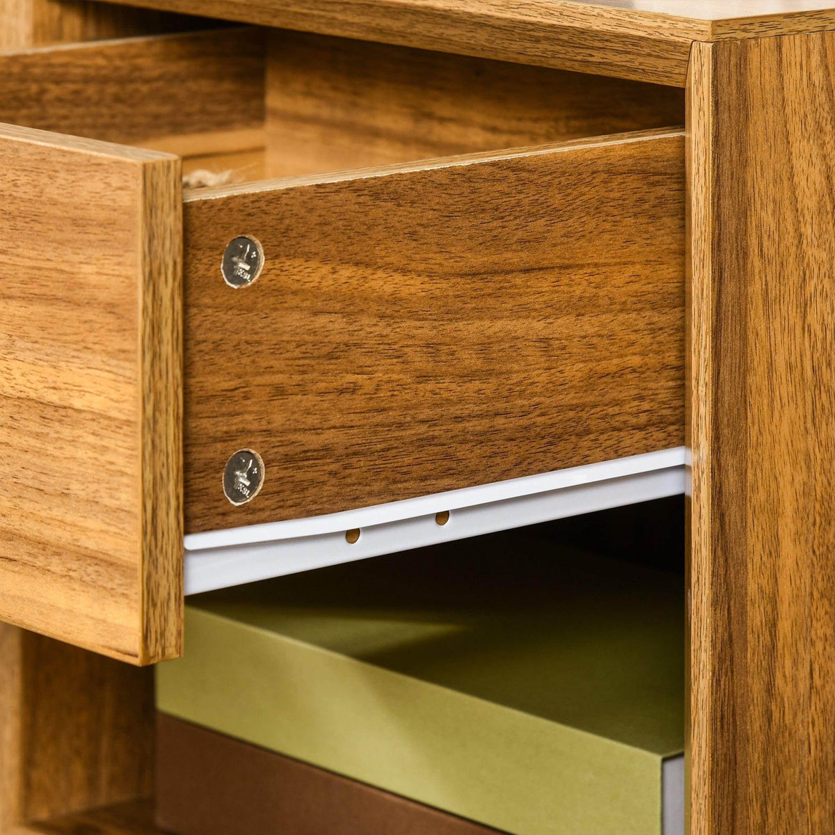 Wooden nightstand drawer front with two metal pulls and open lower storage