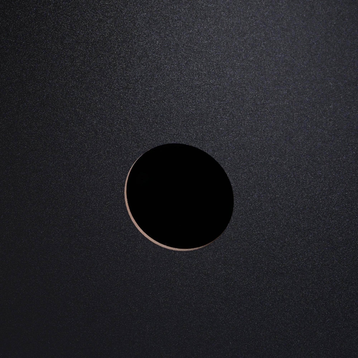 Black cabinet surface with round ventilation hole detail