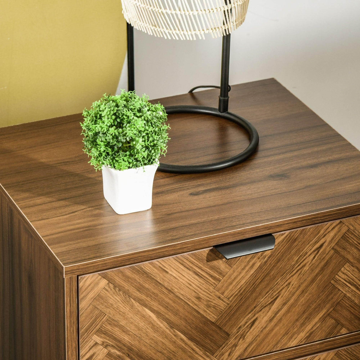 Walnut side cabinet top with potted plant; drawer front with black hidden handle