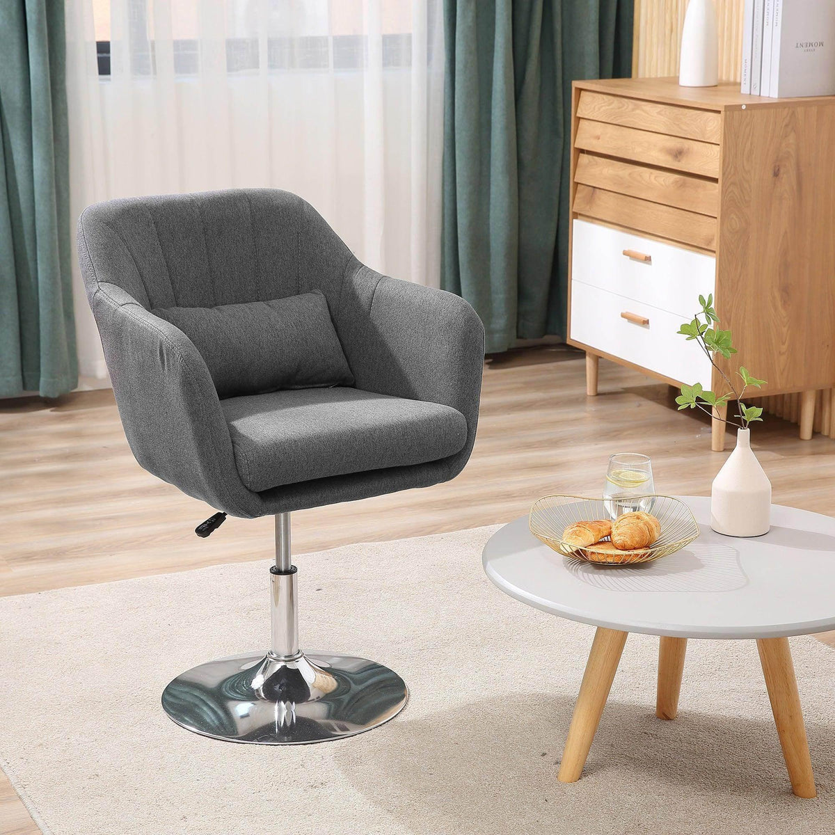 Dark grey swivel tub chair with padded armrests and chrome round pedestal base