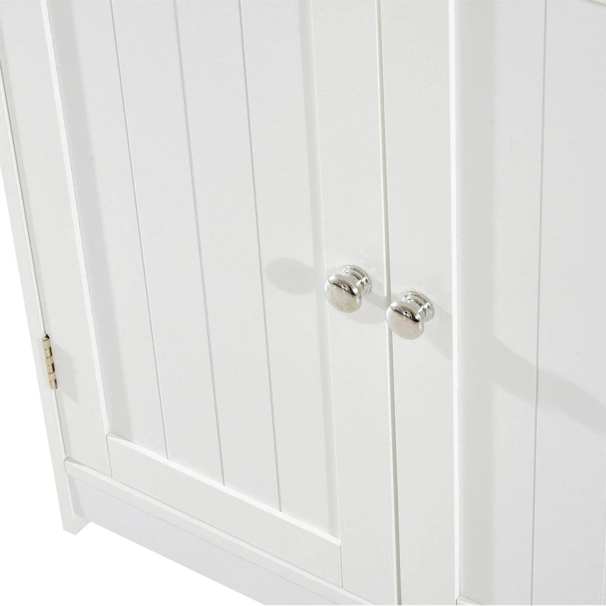 White cabinet door close-up with two silver knob pulls and vertical paneling
