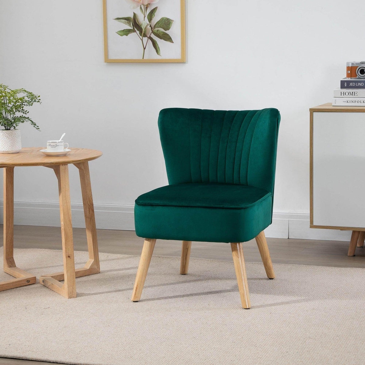 Green velvet accent tub chair with curved back, channel tufting, and light wood legs
