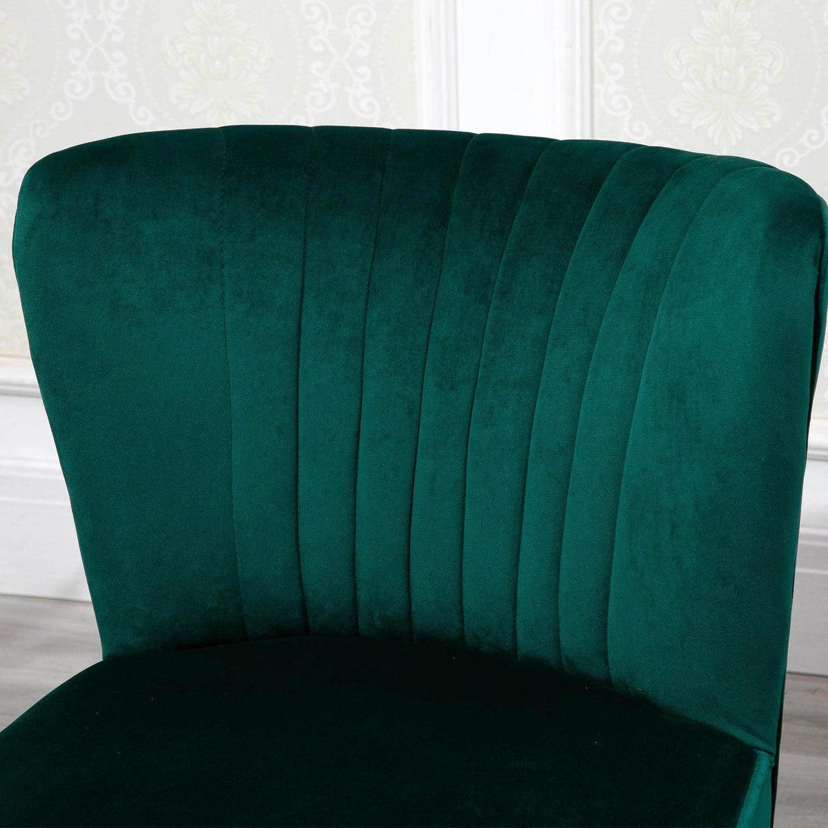 Green velvet tub chair back with vertical channel tufting