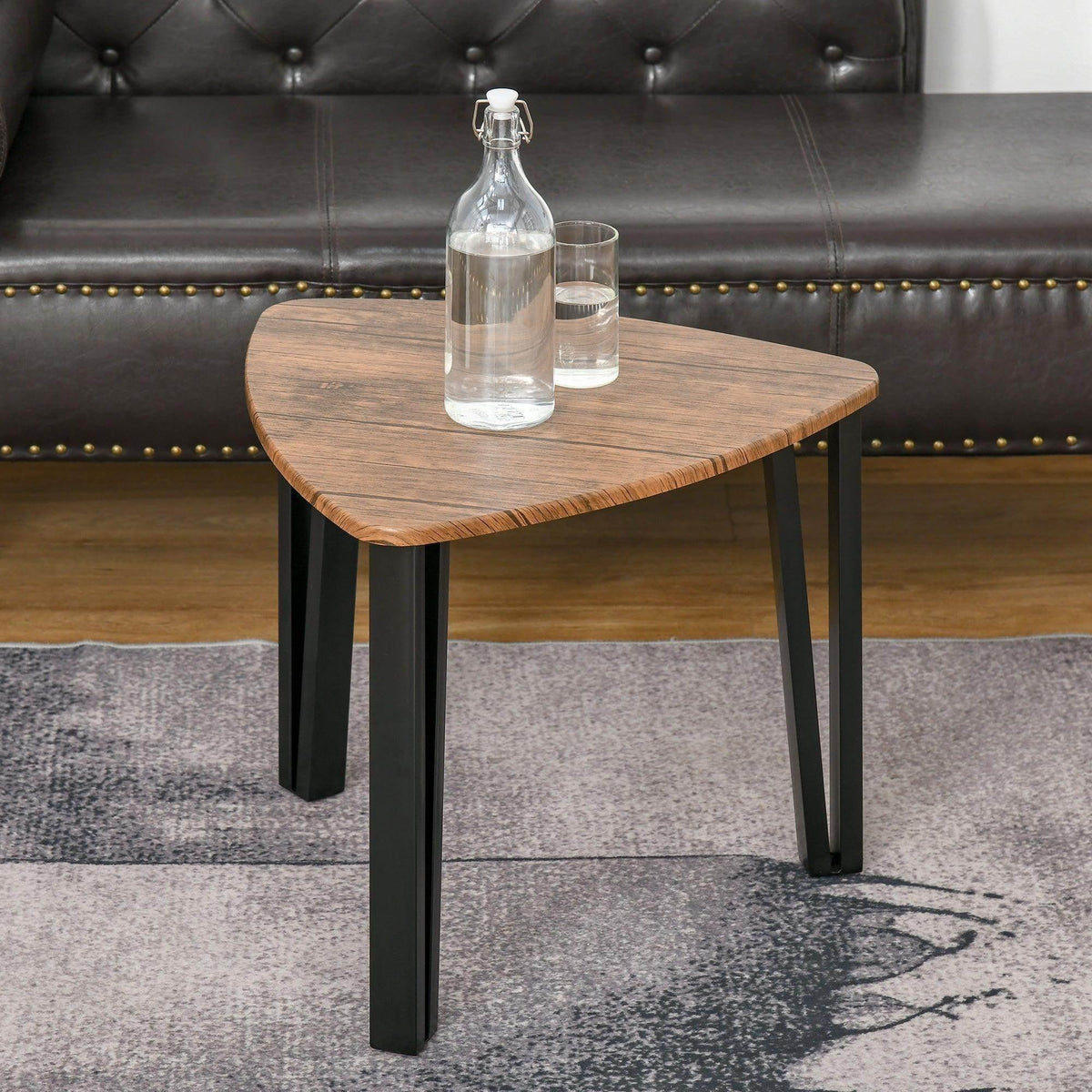 Walnut-tone coffee table with rounded top and black legs