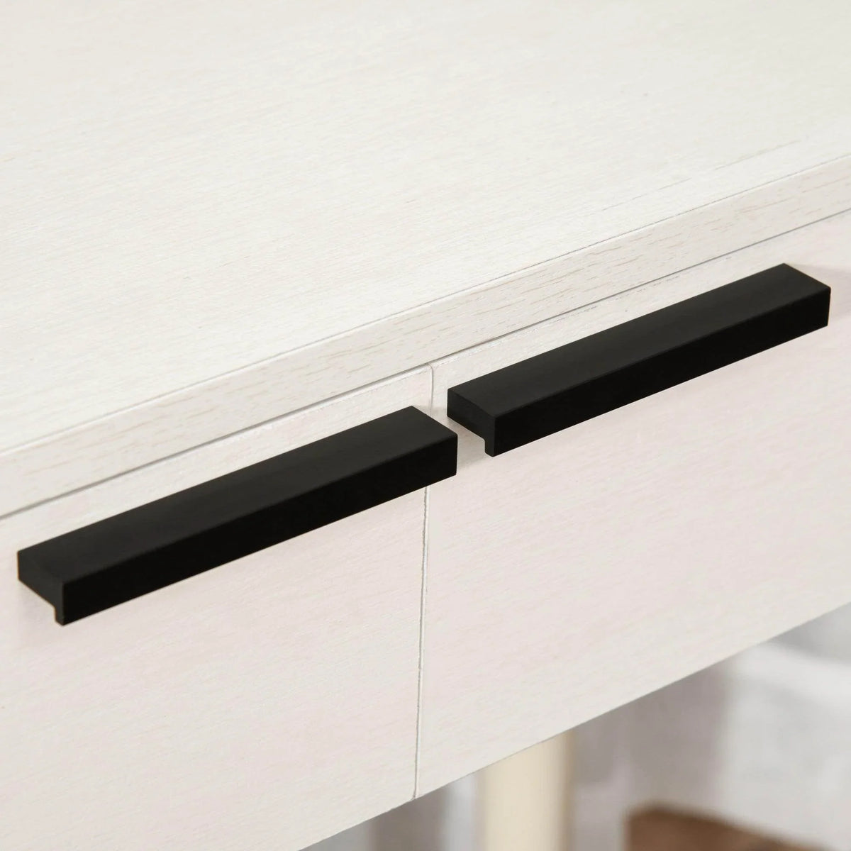 White vanity table drawer front with two long black bar handles