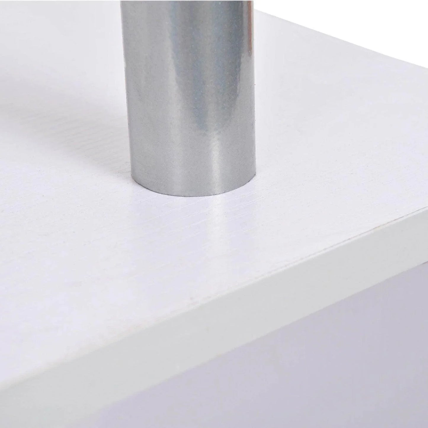 Close-up of a silver metallic pole attached to a white wooden surface, part of modern home furniture
