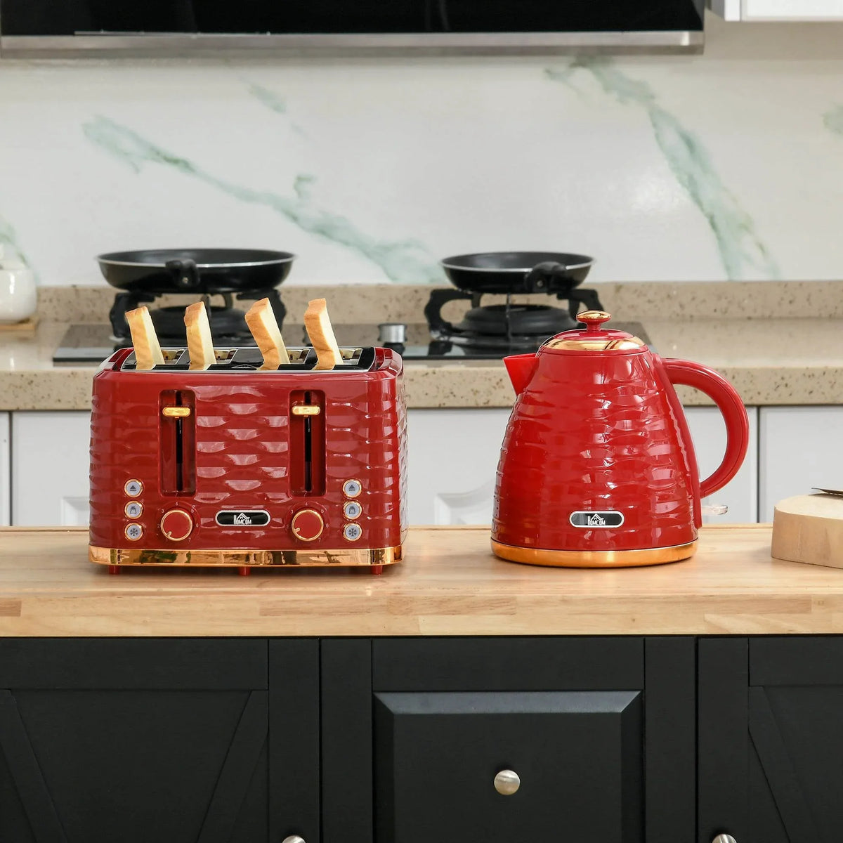 Red toaster and kettle set on kitchen counter with wooden board
