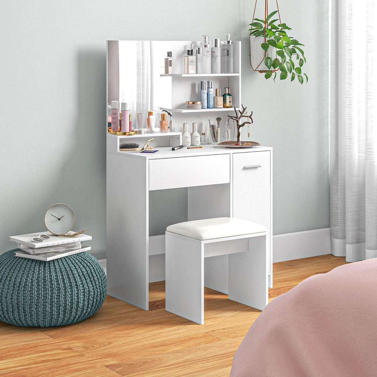 White vanity cabinet with mirror, open storage shelves, and matching upholstered stool