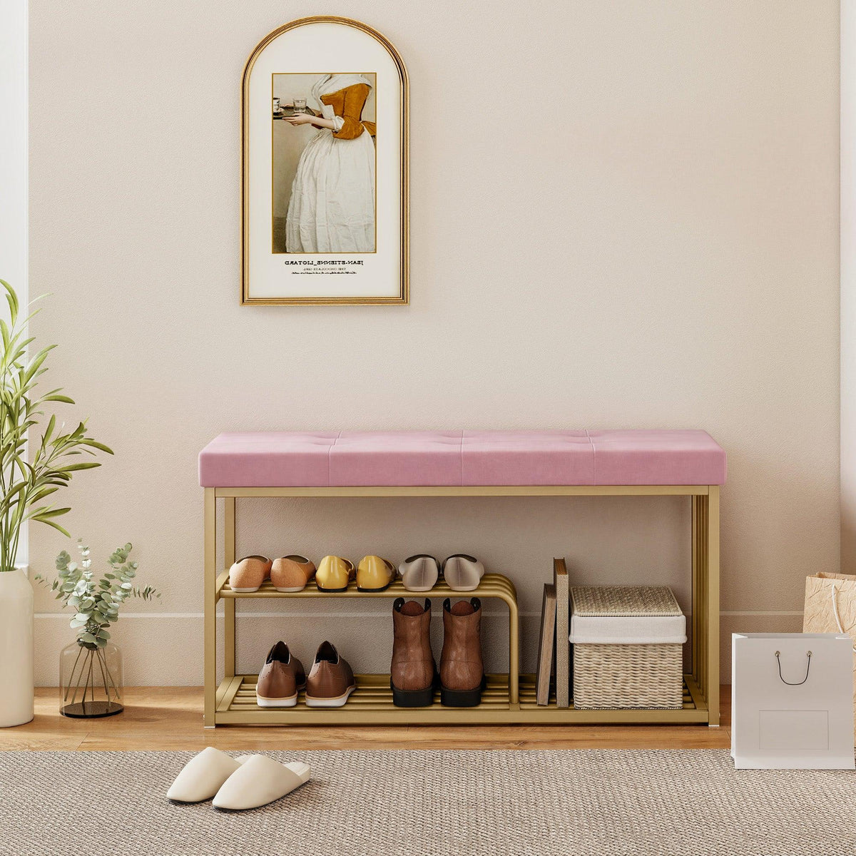 Pink velvet shoe bench with gold frame and open front shelf holding shoes