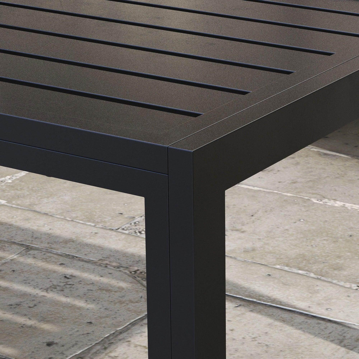 Close-up of black slatted tabletop on a rectangular outdoor side table