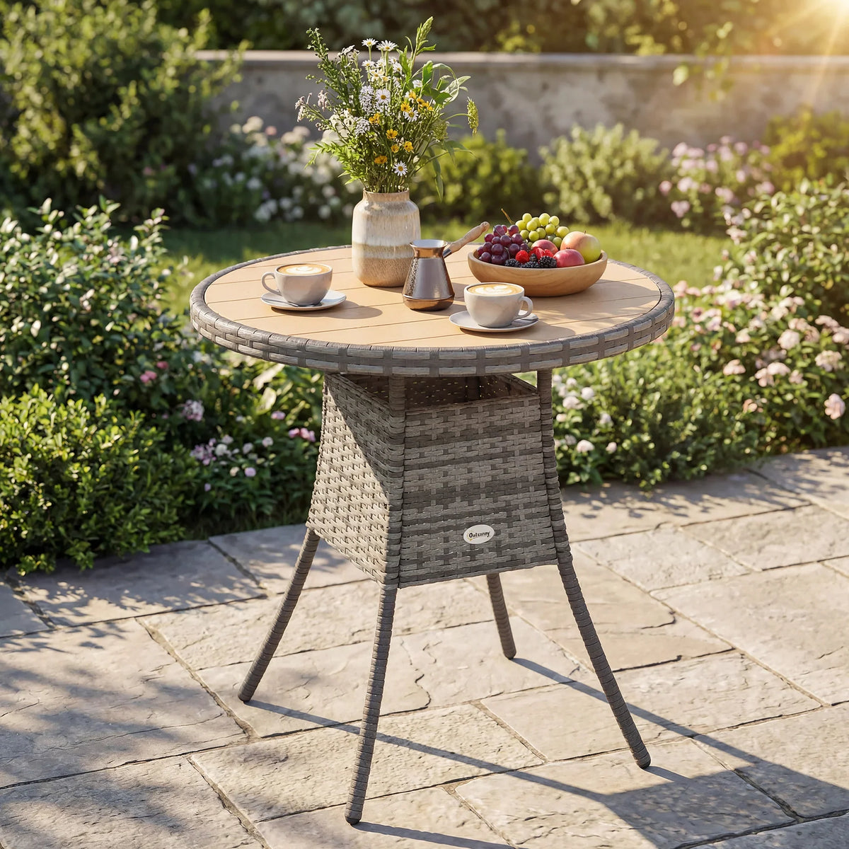 Round garden table with gray rattan-look sides, light top, and four angled metal legs