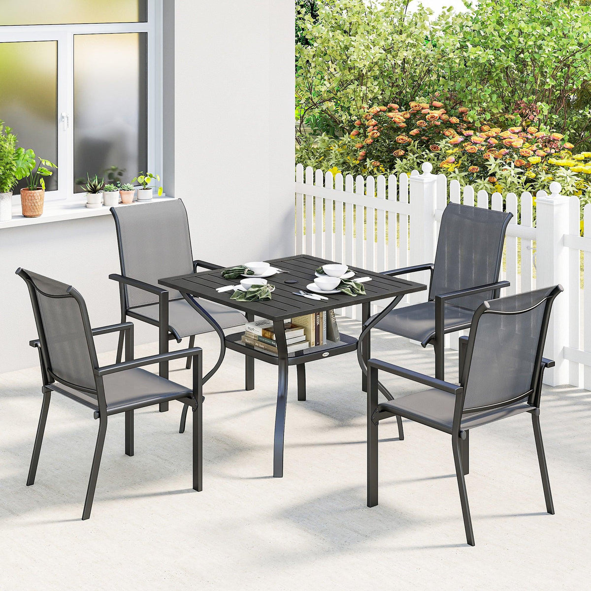 Grey outdoor dining table with four mesh stackable chairs