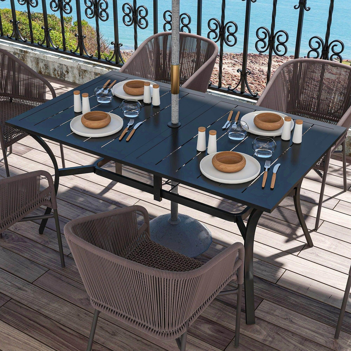 Black rectangular patio dining table with slat top and central umbrella pole