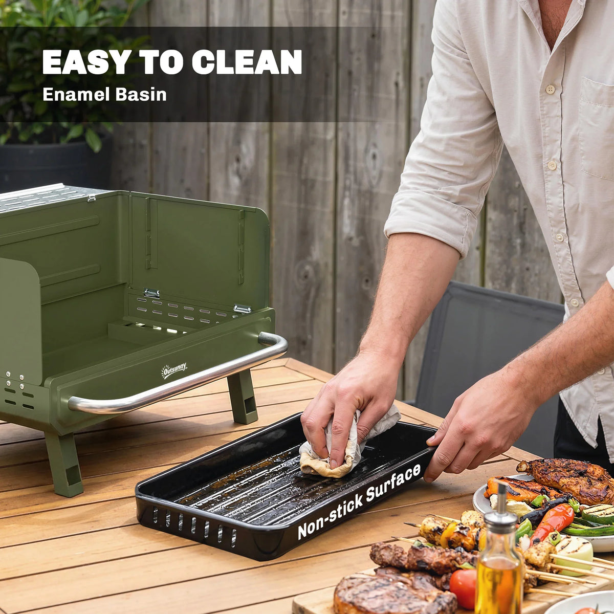 Green charcoal grill with enamel basin and non-stick cooking surface being cleaned