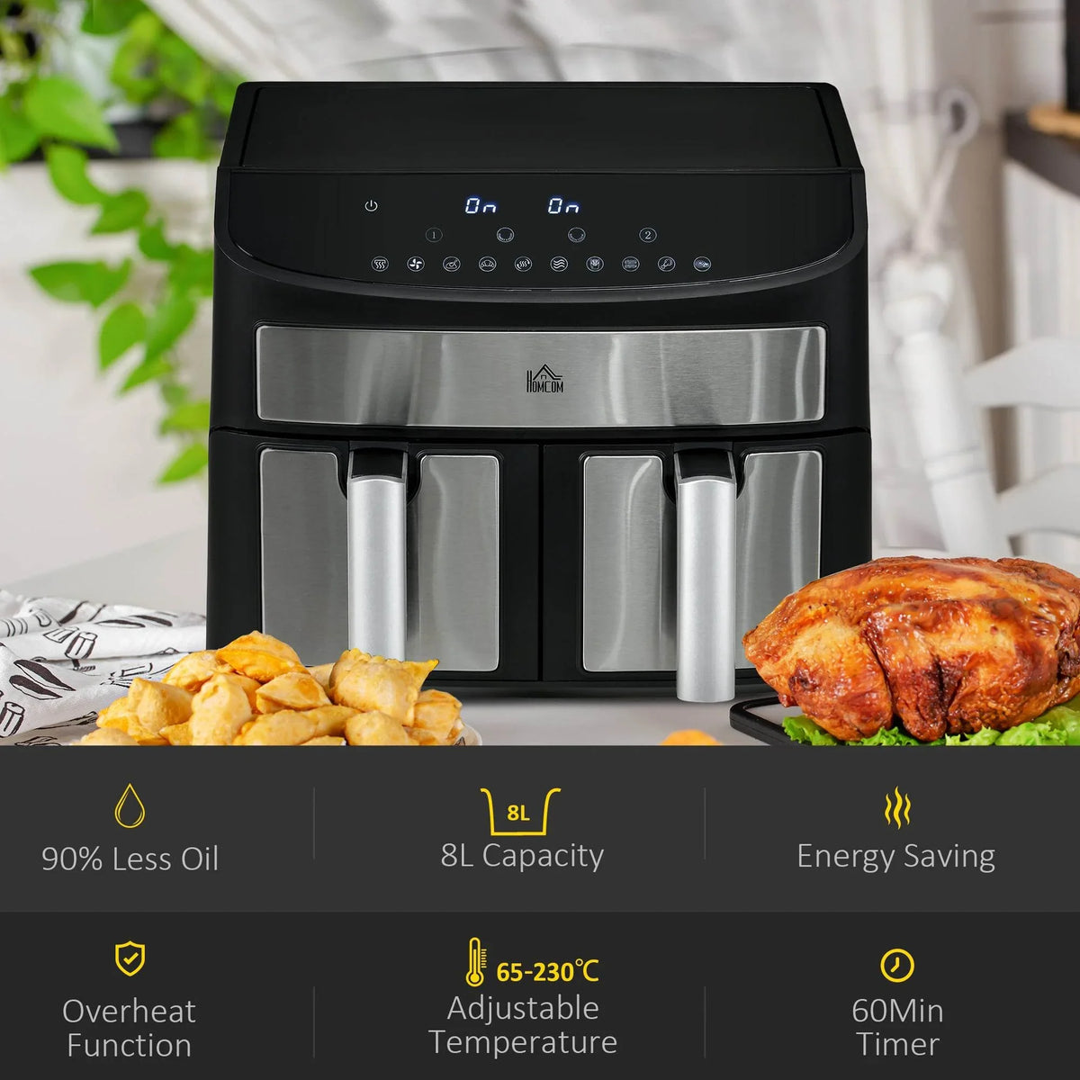 Dual-zone air fryer in black and stainless with roasted chicken and potato pieces on counter